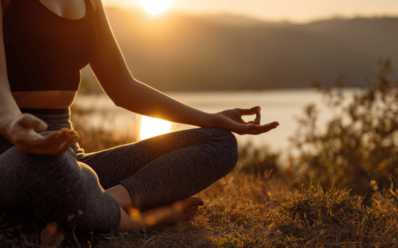 Person practicing mindfulness outdoors during a moment of self-care