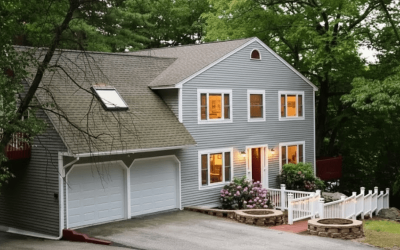 Welcoming exterior of a recovery center surrounded by trees, conveying safety, stability, and support for people returning to treatment