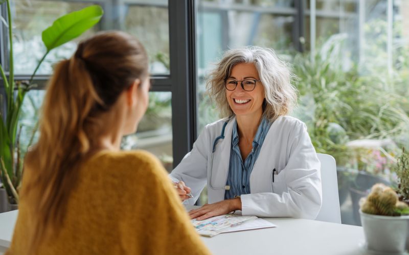 Medical professional discussing medication-assisted treatment options with patient in consultation room at New Hampshire treatment center